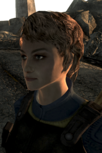 Screenshot of Kimberly from Fallout 3. She is a young woman with short champagne-colored hair, a delicate jaw, and large green eyes.
